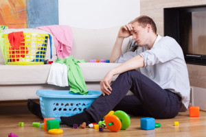 Lonly tired father sitting with child's toys